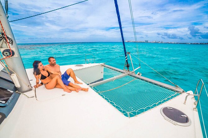 Catamaran to Isla Mujeres Snorkeling Tour with Open Bar and Lunch - Spinnaker, drinks, and the party-boat mood