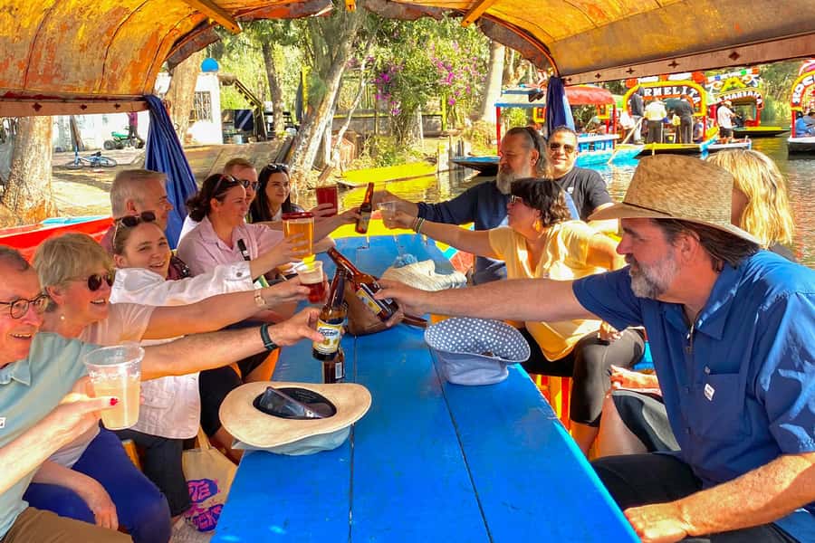 CDMX: Xochimilco Trajinera Party, Drinks, Mariachi & Tacos - Boarding a flower-covered trajinera