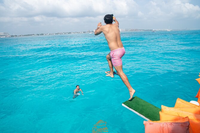 Dancer Cruise Isla Mujeres Snorkel Food and Drinks Included - Slide, trampoline, and jump board time
